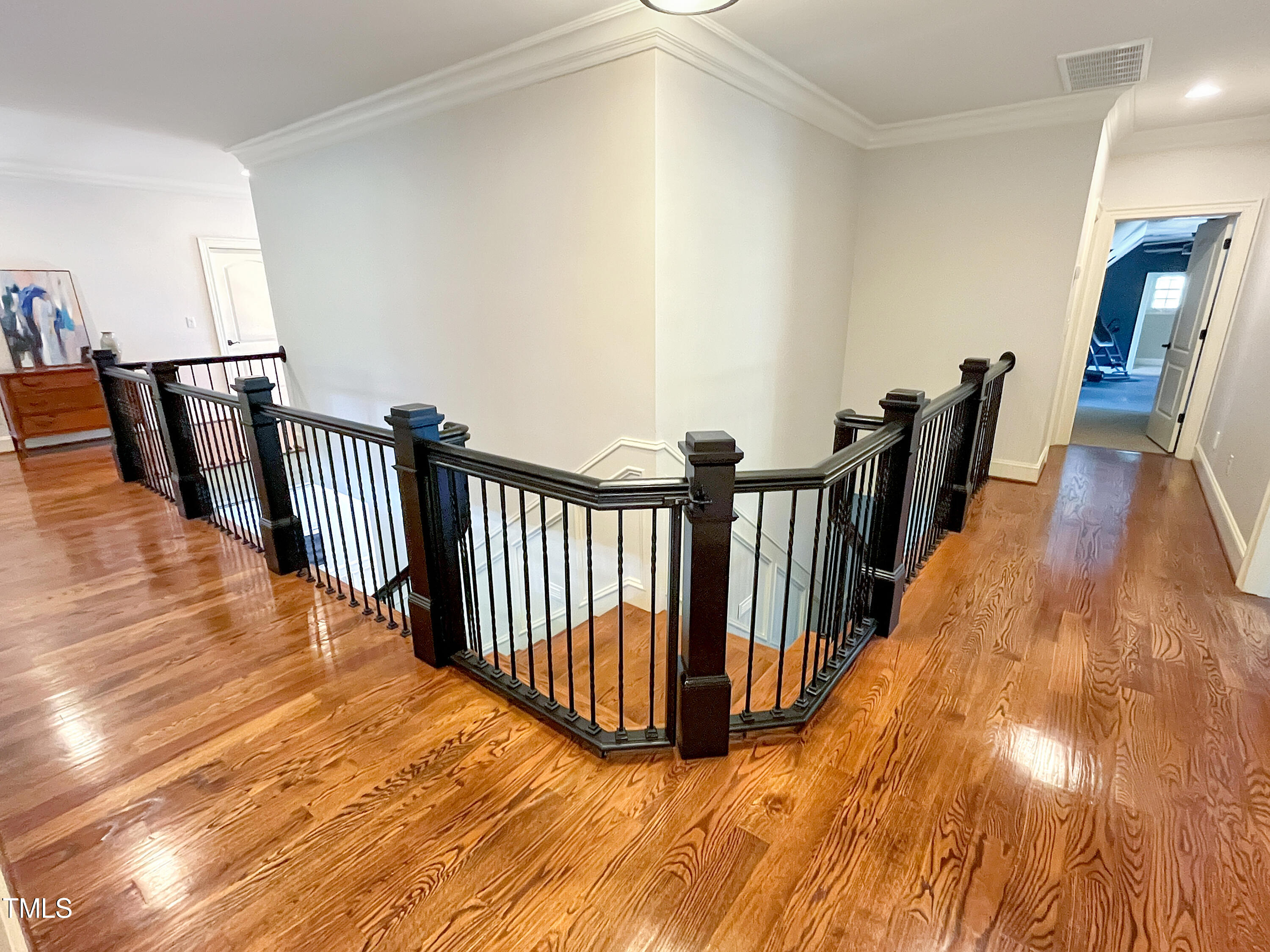 2908 Claremont Road Raleigh, NC 27608 - Photo 29 of 46 a view of a hallway with wooden floor and stairs