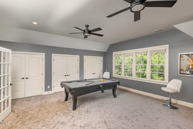 a living room with pool table furniture and a window