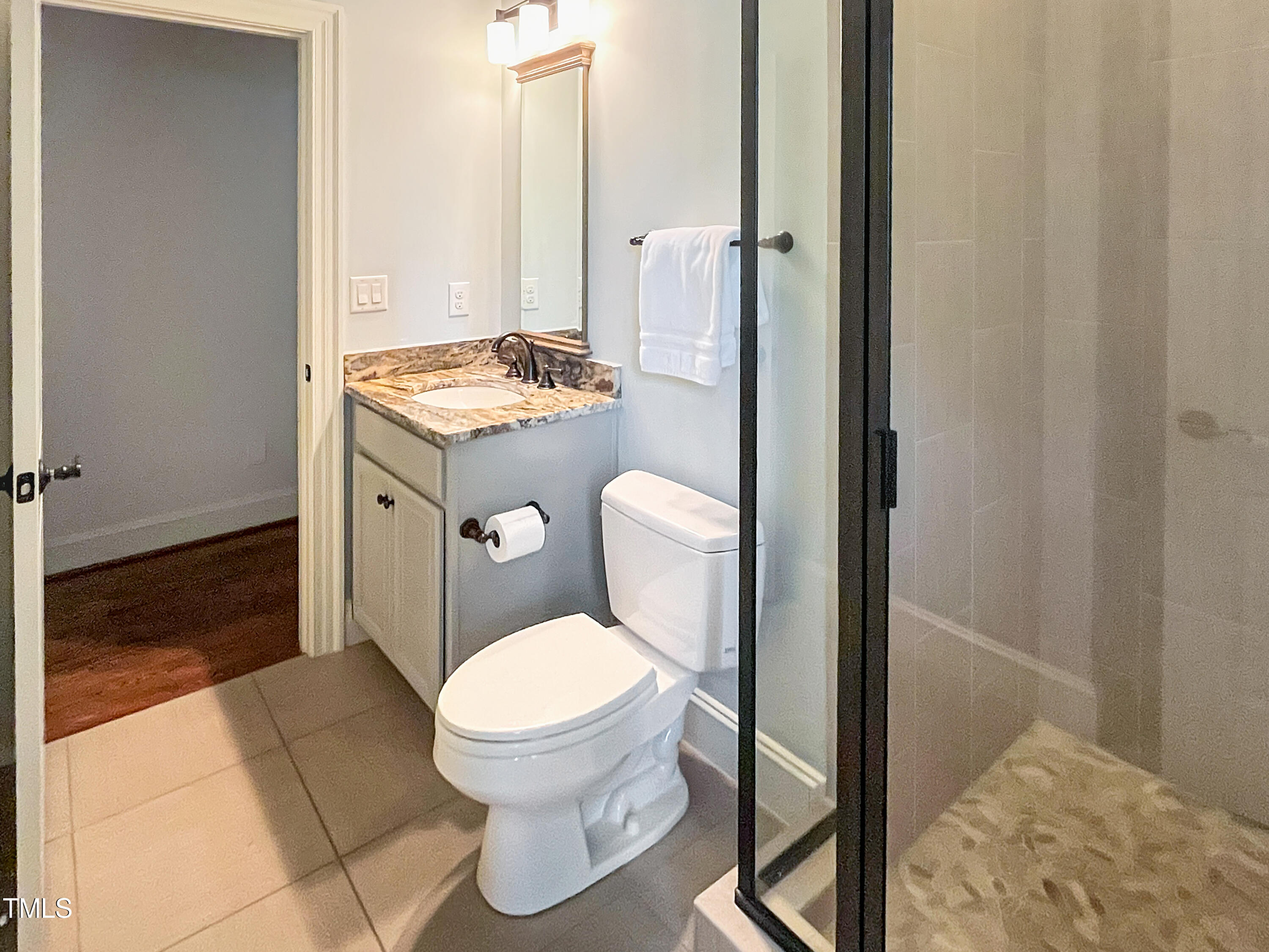 2908 Claremont Road Raleigh, NC 27608 - Photo 34 of 46 a bathroom with a granite countertop toilet and a sink