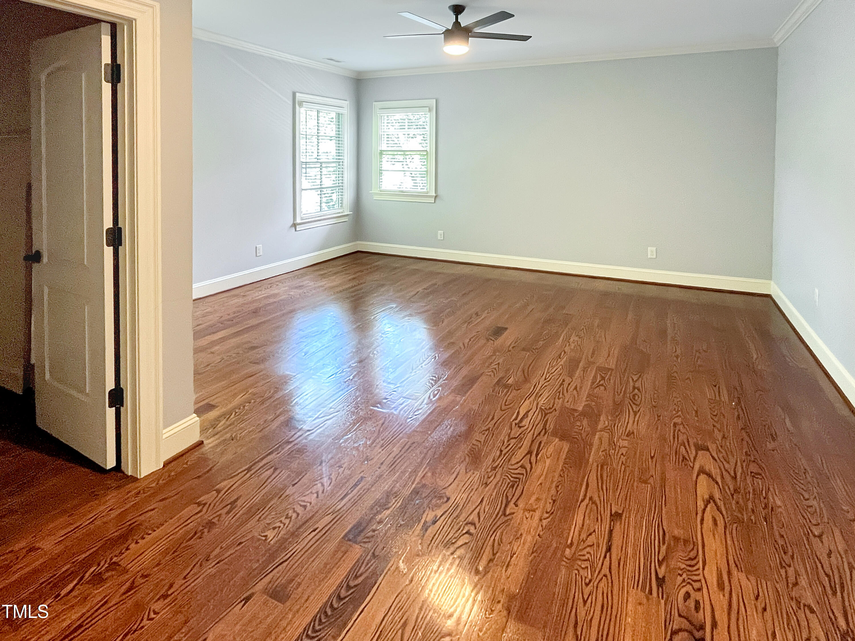 2908 Claremont Road Raleigh, NC 27608 - Photo 36 of 46 a view of an empty room with wooden floor and a window