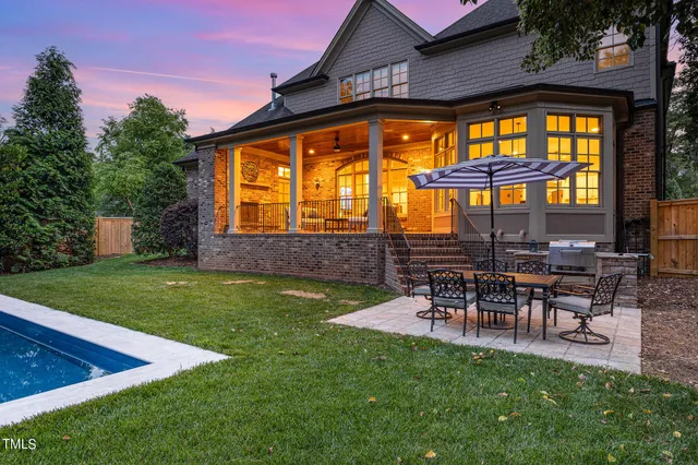 a view of a house with a backyard and a patio