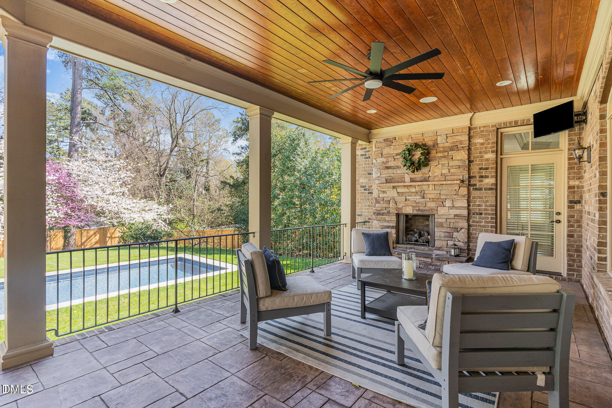 2908 Claremont Road Raleigh, NC 27608 - Photo 41 of 46 a living room with furniture a fireplace and a floor to ceiling window