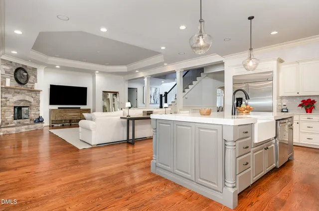 a large white kitchen with stainless steel appliances