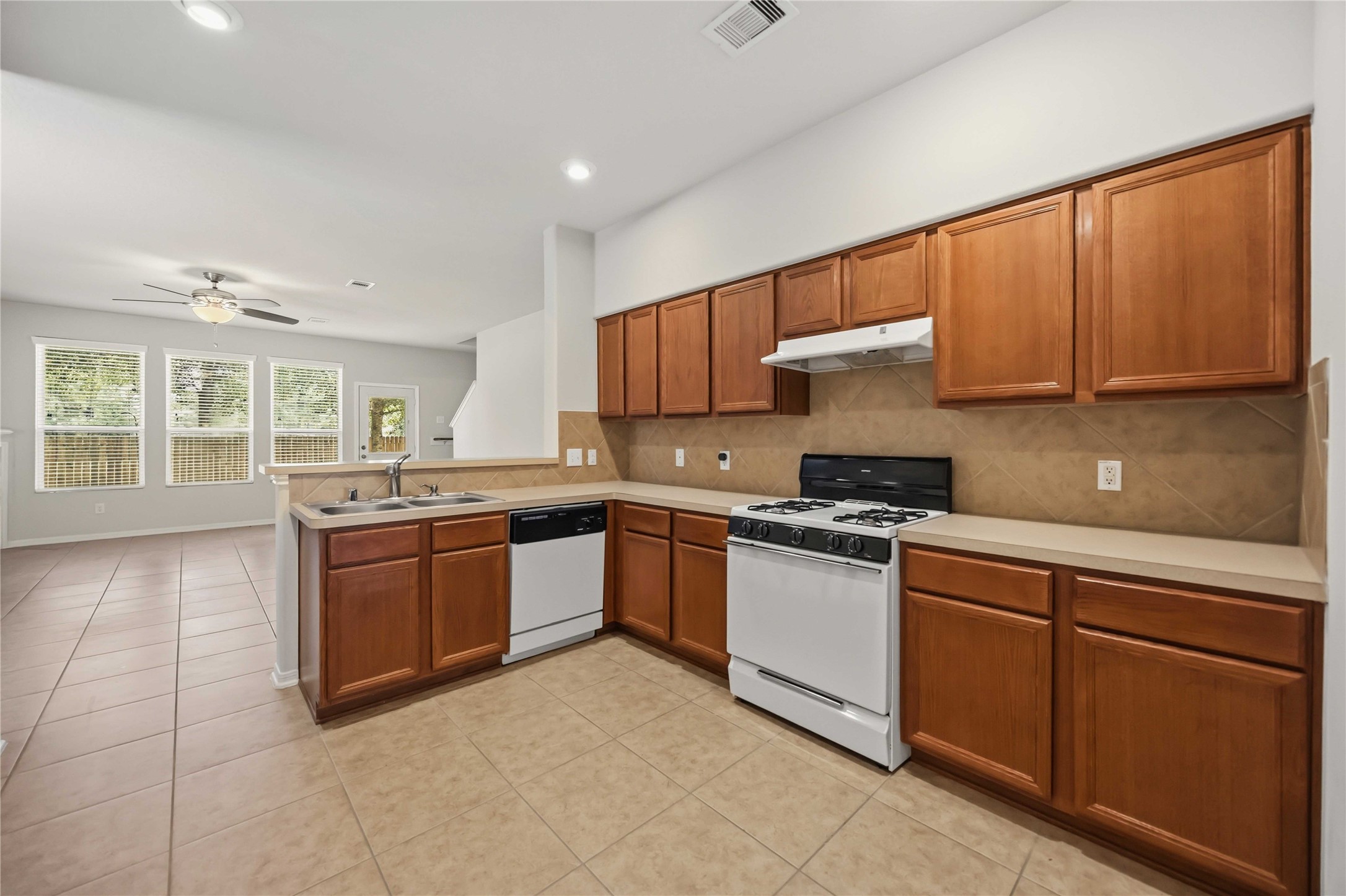 29526 Winton Wood Way Spring, TX 77386 - Photo 8 of 29 Alternate kitchen view showcasing the functional layout, ample cabinetry, and abundant prep space.