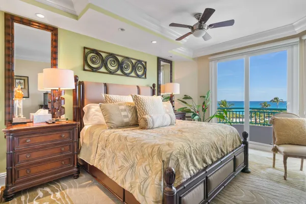 a bed room with furniture and floor to ceiling window