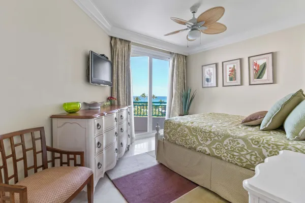 a bedroom with a bed and dresser with mirror