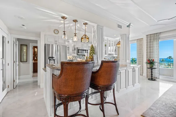 a large kitchen with a lot of counter space and wooden floor