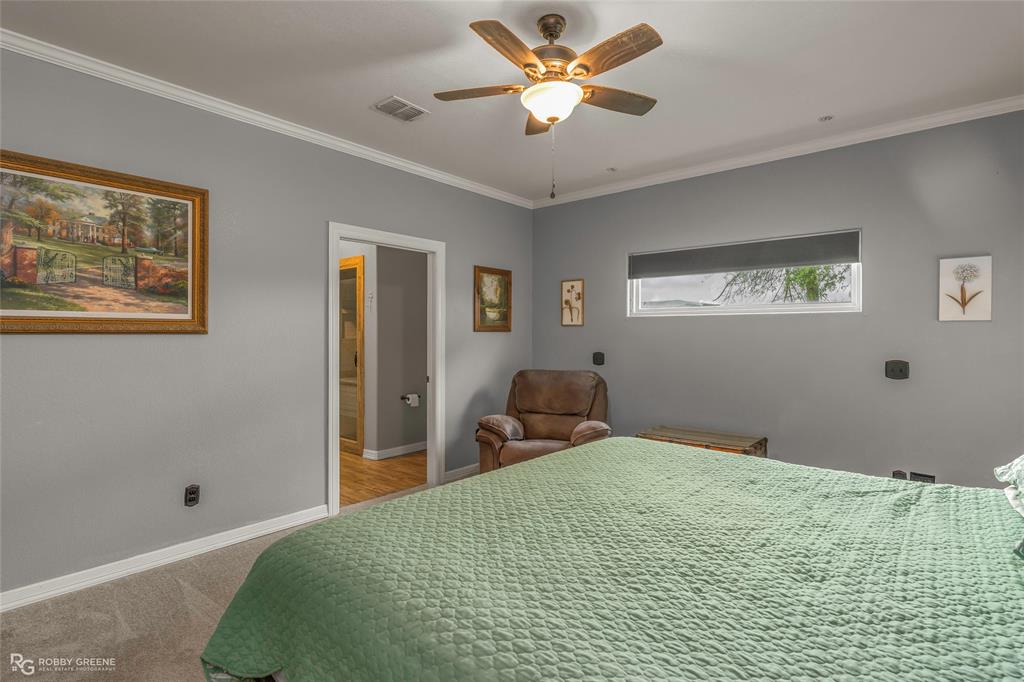 624 Holly Street Grand Cane, LA 71032 - Photo 13 of 40 Carpeted bedroom with ornamental molding and ceiling fan