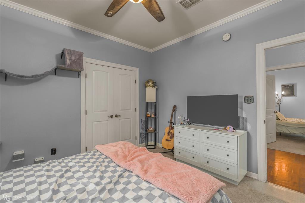624 Holly Street Grand Cane, LA 71032 - Photo 22 of 40 Bedroom featuring light colored carpet, ornamental molding, ceiling fan, and a closet