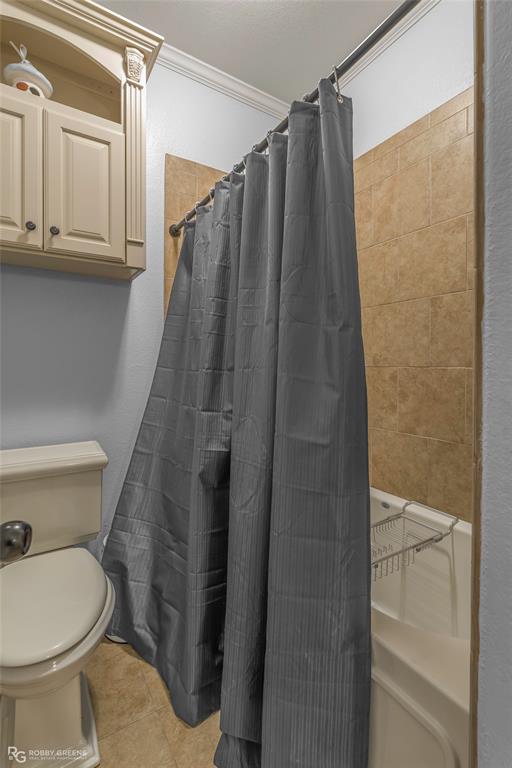 624 Holly Street Grand Cane, LA 71032 - Photo 25 of 40 Bathroom with ornamental molding, a shower with shower curtain, and light tile patterned flooring