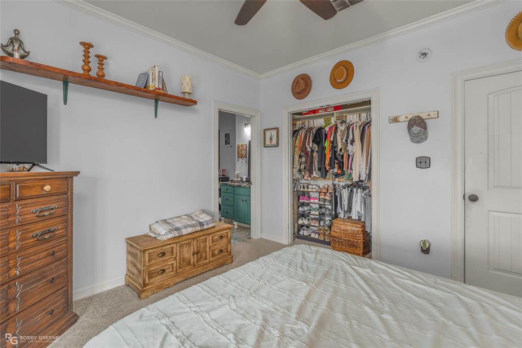 624 Holly Street Grand Cane, LA 71032 - Photo 27 of 40 Bedroom featuring light colored carpet, ornamental molding, a closet, and a ceiling fan