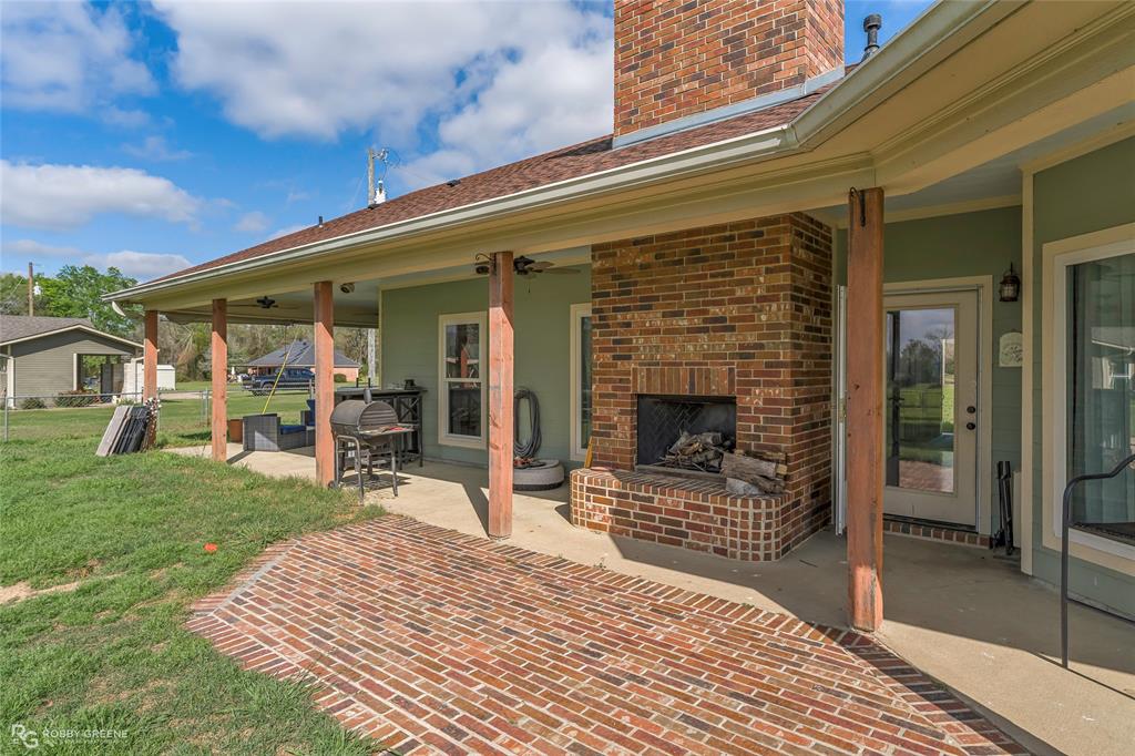 624 Holly Street Grand Cane, LA 71032 - Photo 30 of 40 View of patio / terrace with an outdoor brick fireplace and ceiling fan