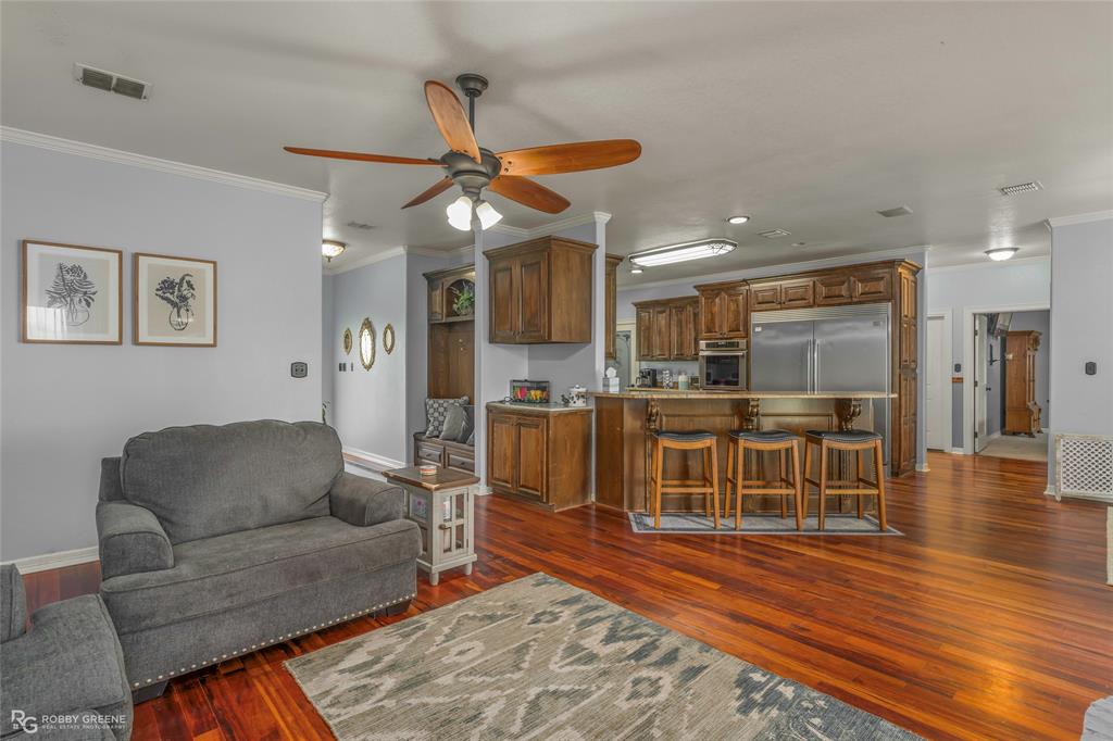 624 Holly Street Grand Cane, LA 71032 - Photo 5 of 40 Living room with crown molding, a ceiling fan, dark wood-style flooring, and recessed lighting