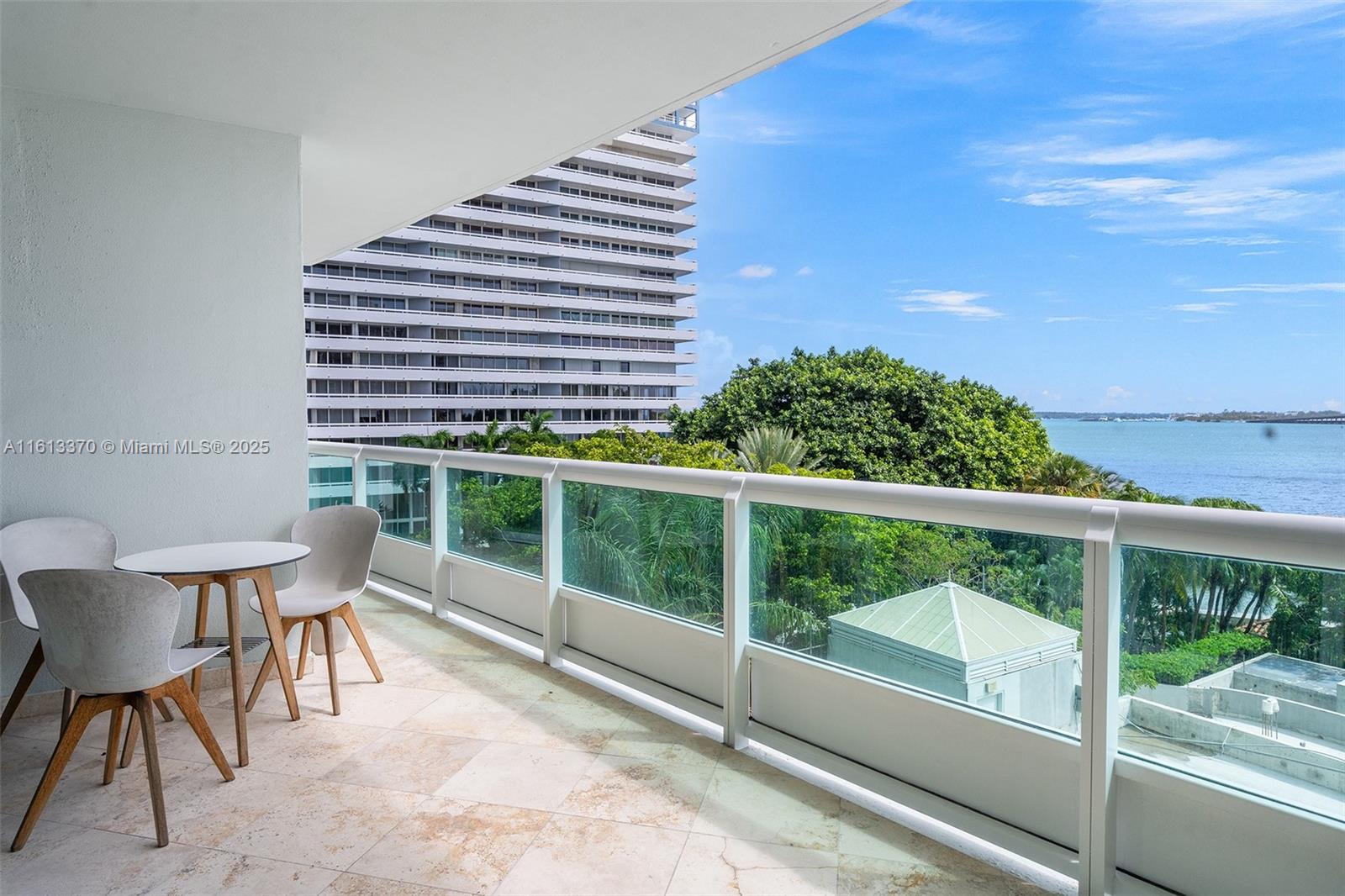 1643 Brickell Avenue, Unit 704 Miami, FL 33129 - Photo 4 of 36 a view of a balcony with chairs