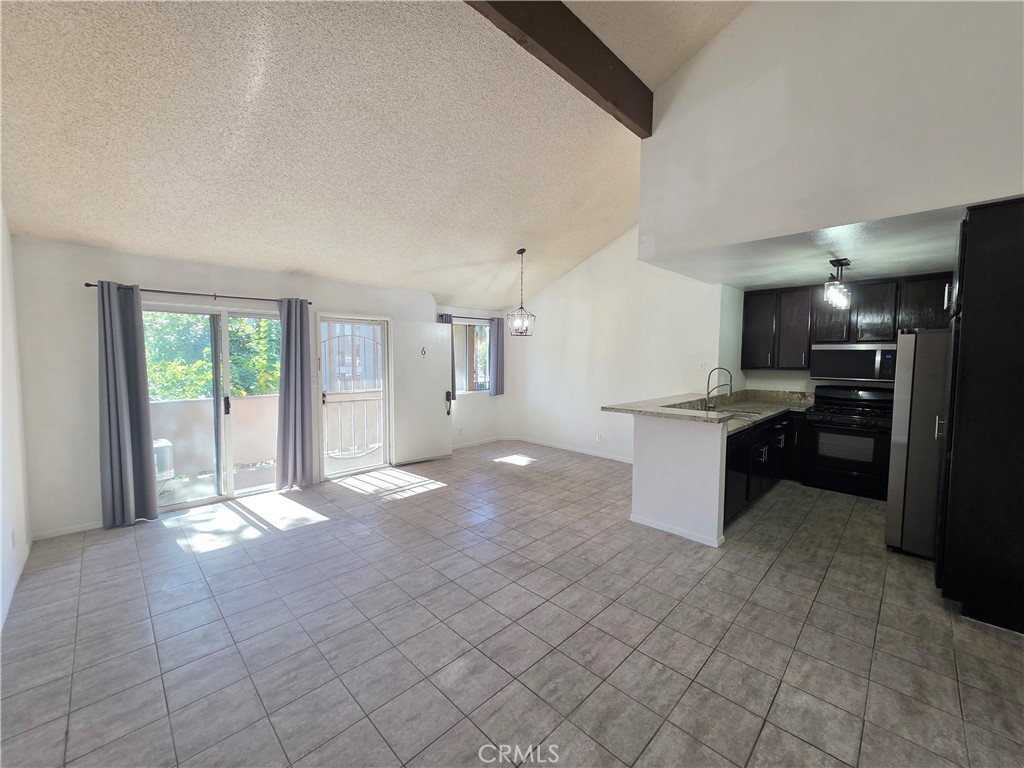 14839 Sherman Way, Unit 6 Van Nuys, CA 91405 - Photo 1 of 23 a view of a kitchen with a sink and an open kitchen view