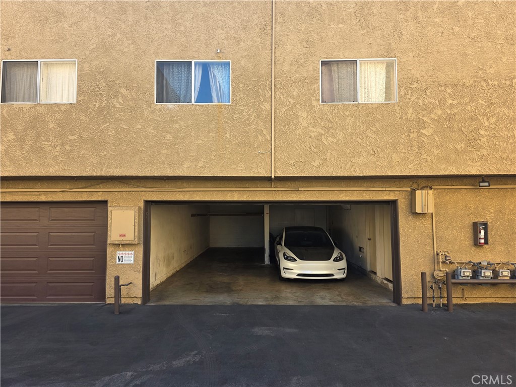 14839 Sherman Way, Unit 6 Van Nuys, CA 91405 - Photo 15 of 23 a car parked in front of a building
