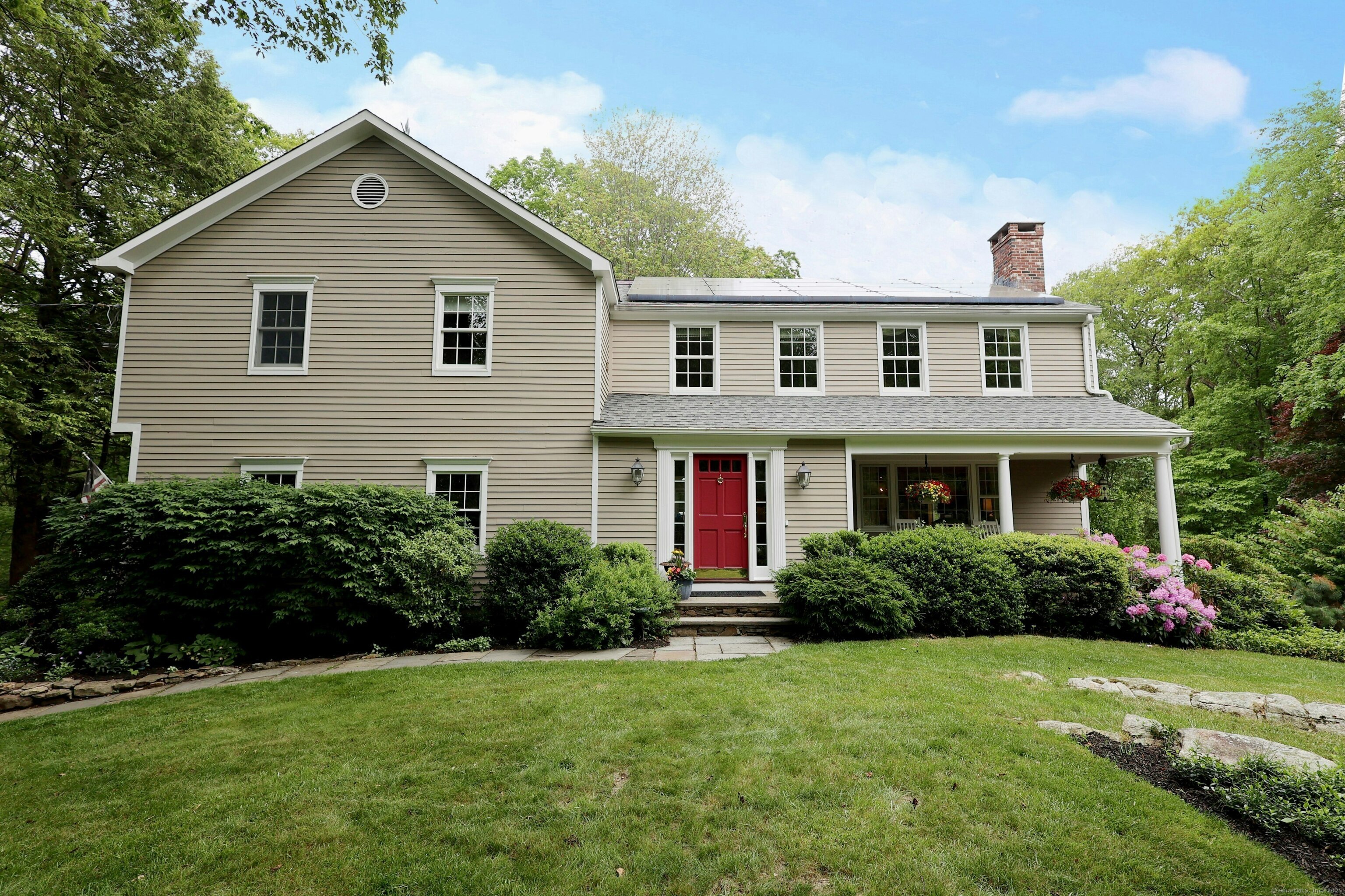 114 Peaceable Ridge Road Ridgefield, CT 06877 - Photo 1 of 1 a front view of a house with a yard
