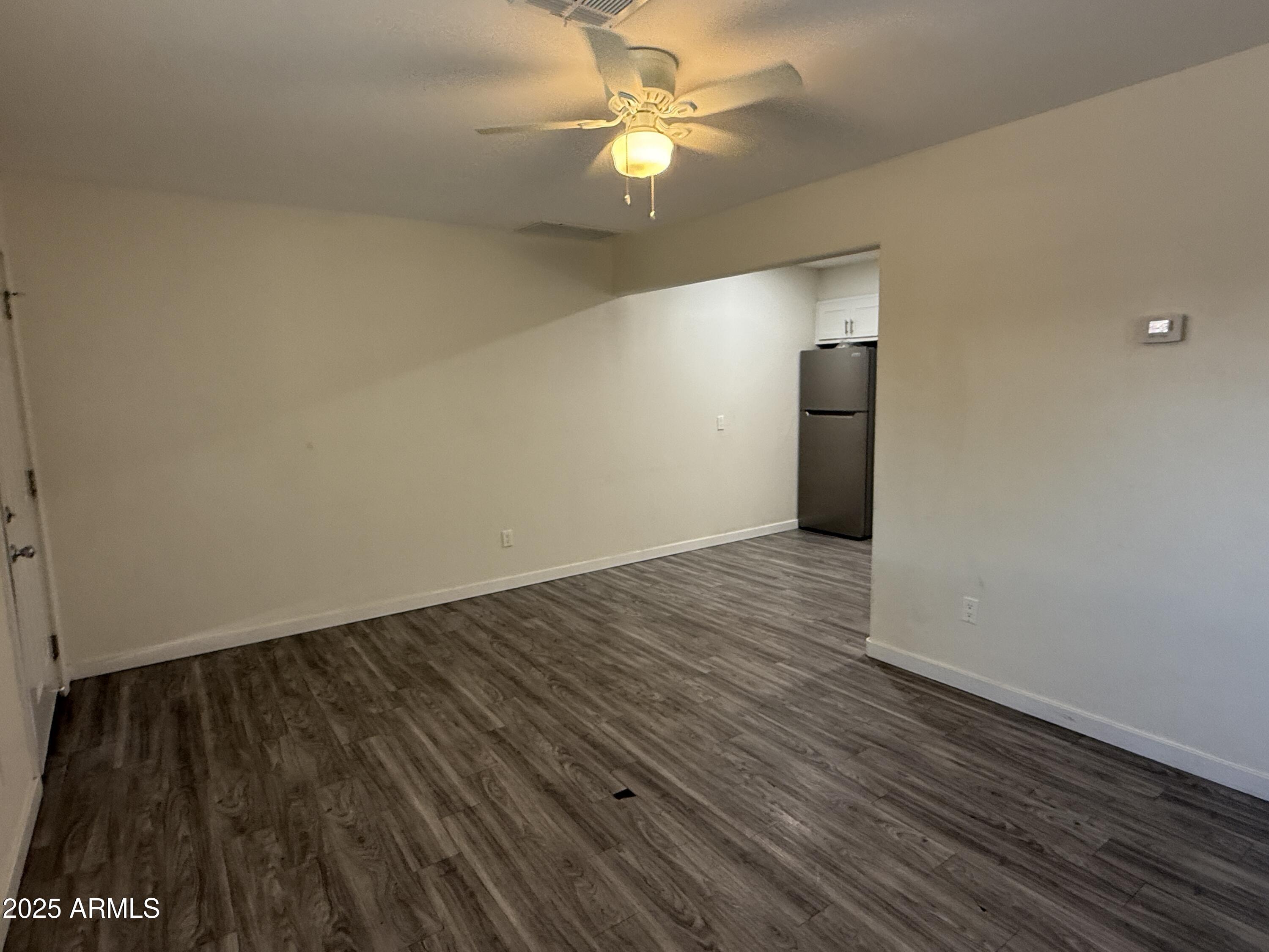 1625 West Fillmore Street, Unit 1 Phoenix, AZ 85007 - Photo 3 of 10 wooden floor in an empty room with a window