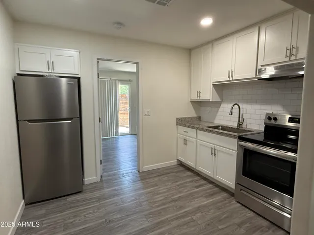 a kitchen with a refrigerator and a sink
