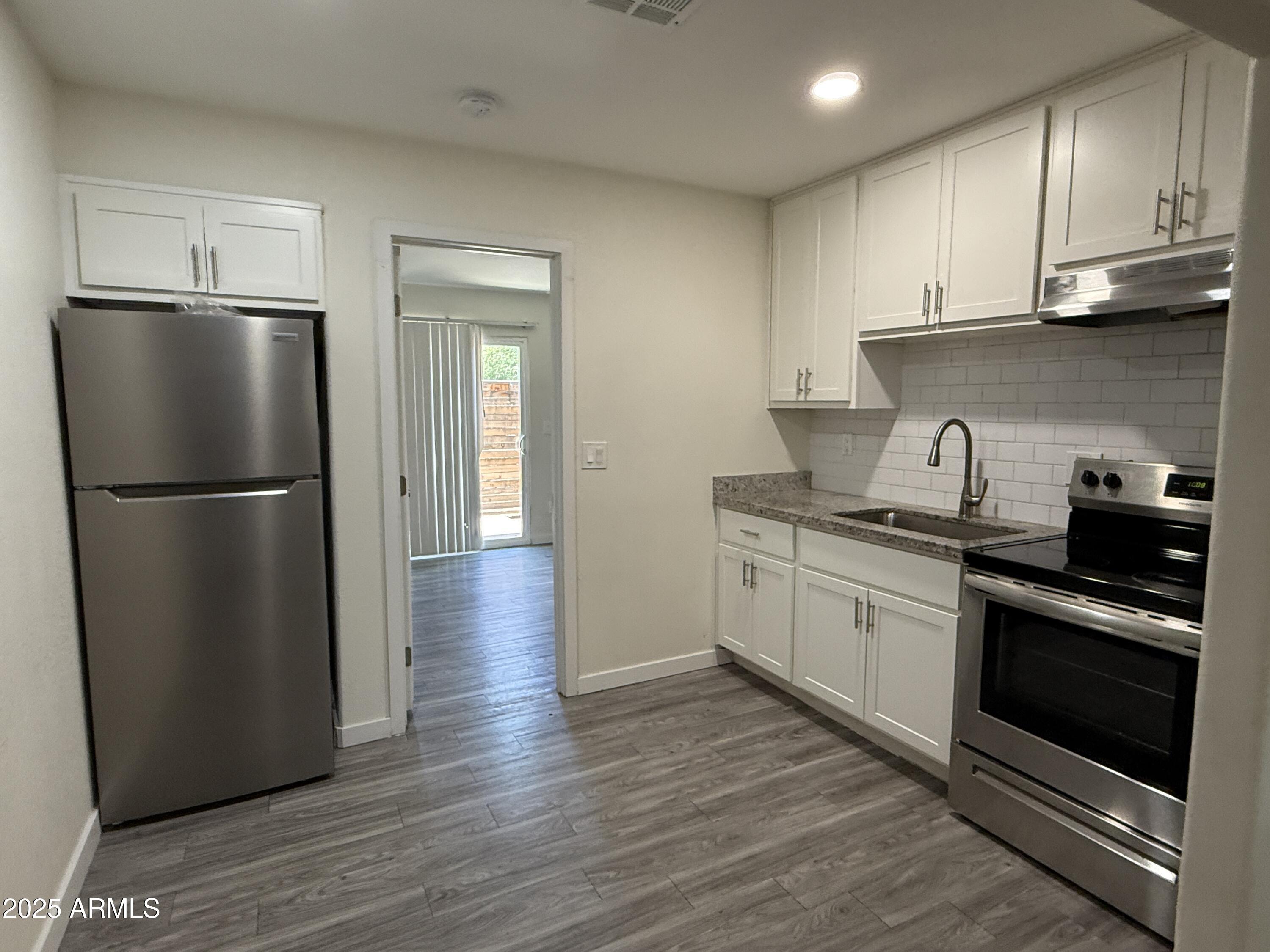 1625 West Fillmore Street, Unit 1 Phoenix, AZ 85007 - Photo 4 of 10 a kitchen with a refrigerator and a sink