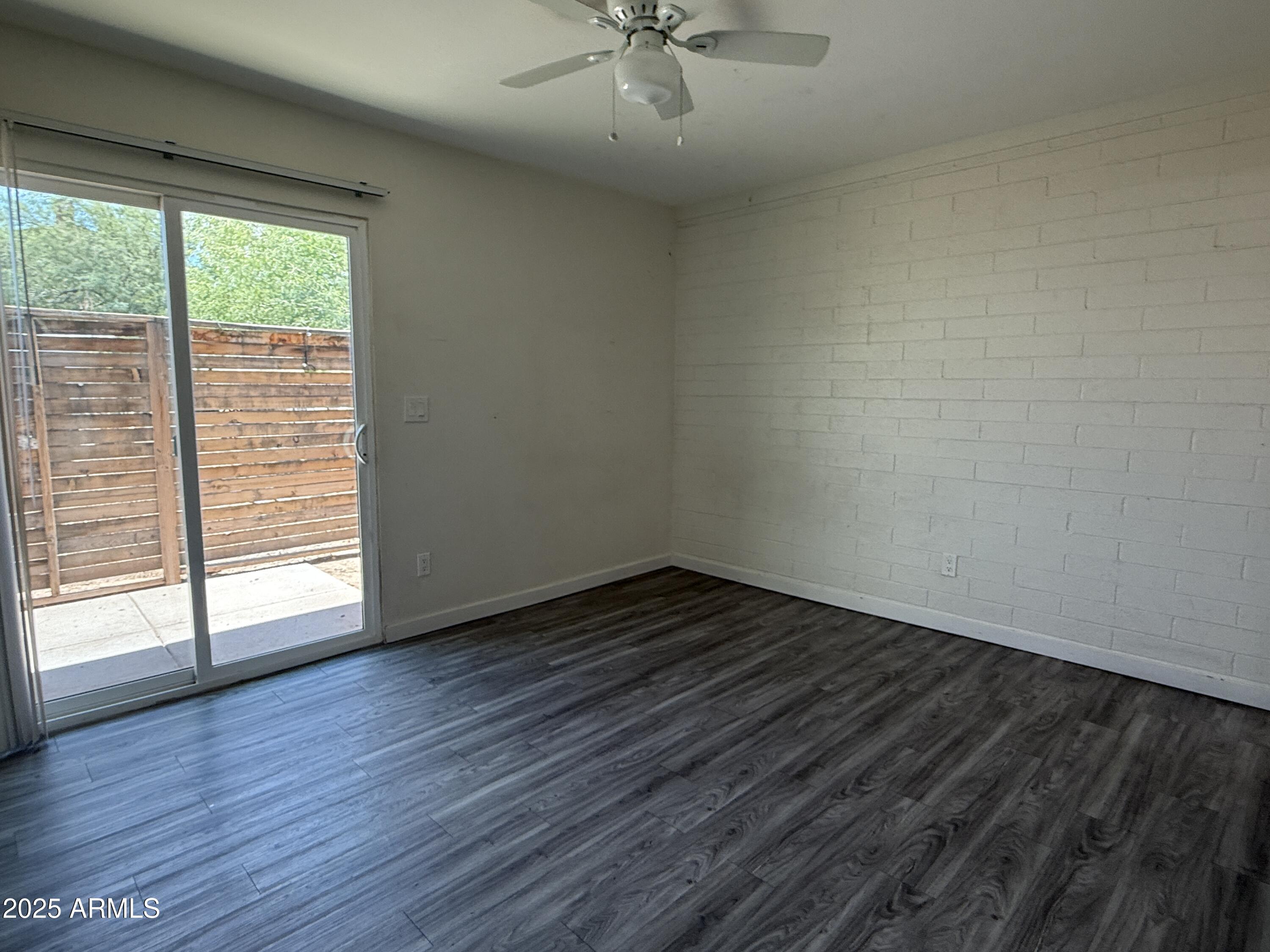 1625 West Fillmore Street, Unit 1 Phoenix, AZ 85007 - Photo 6 of 10 wooden floor in an empty room with a window