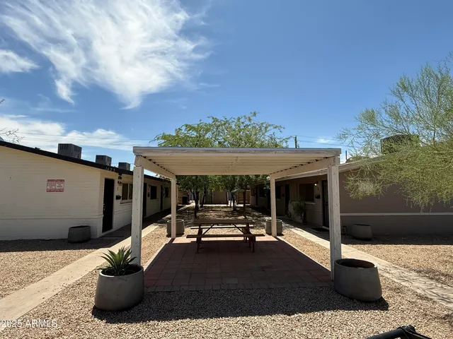 a view of a patio with table and chairs