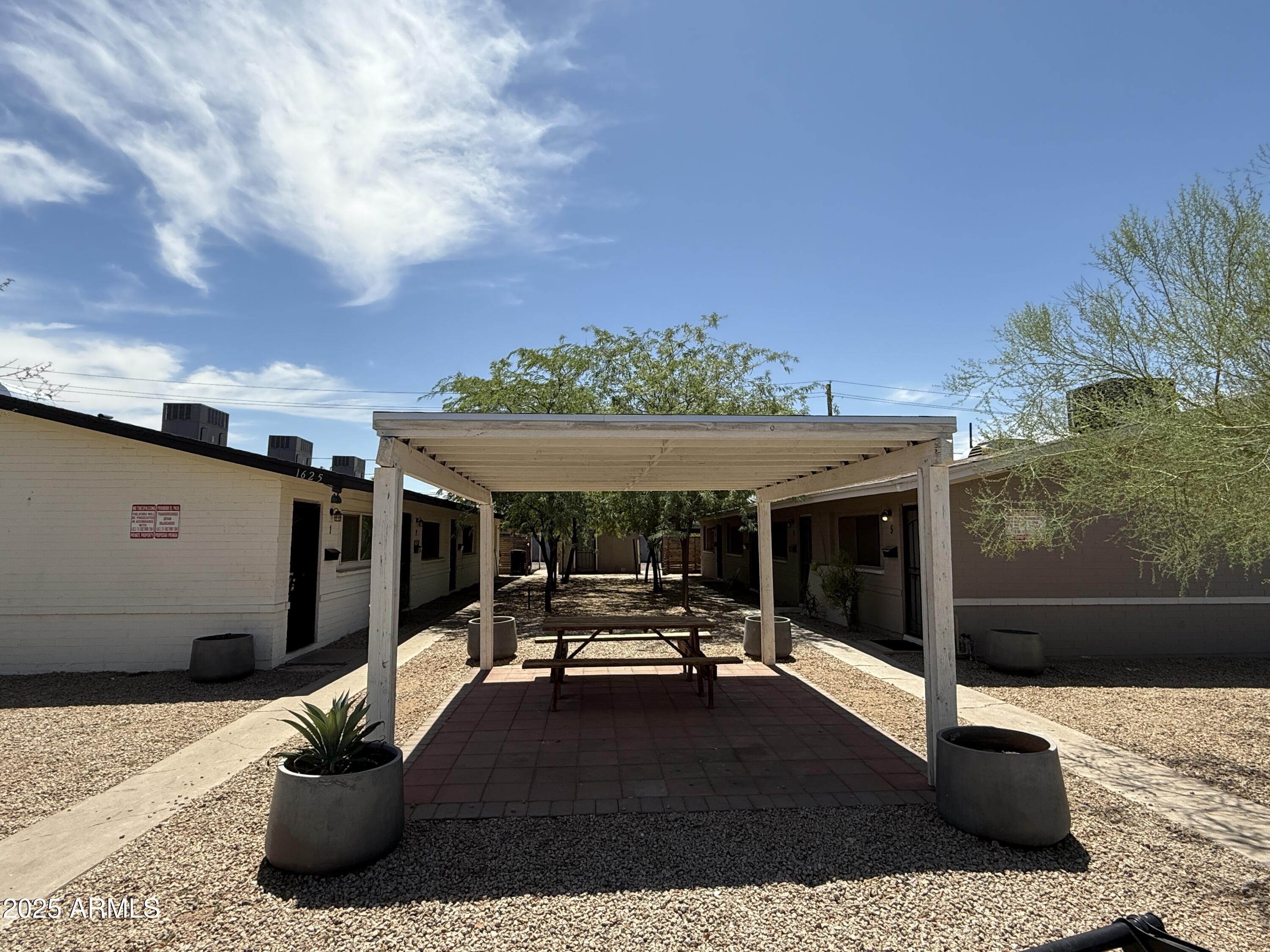 1625 West Fillmore Street, Unit 1 Phoenix, AZ 85007 - Photo 10 of 10 a view of a patio with table and chairs