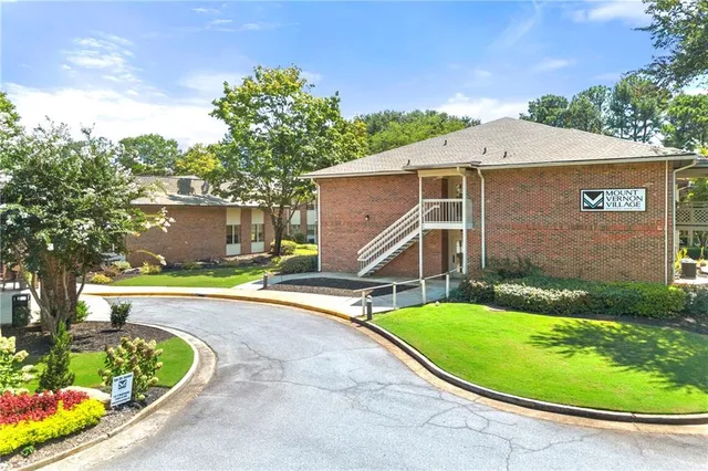a view of a house with a yard potted plants