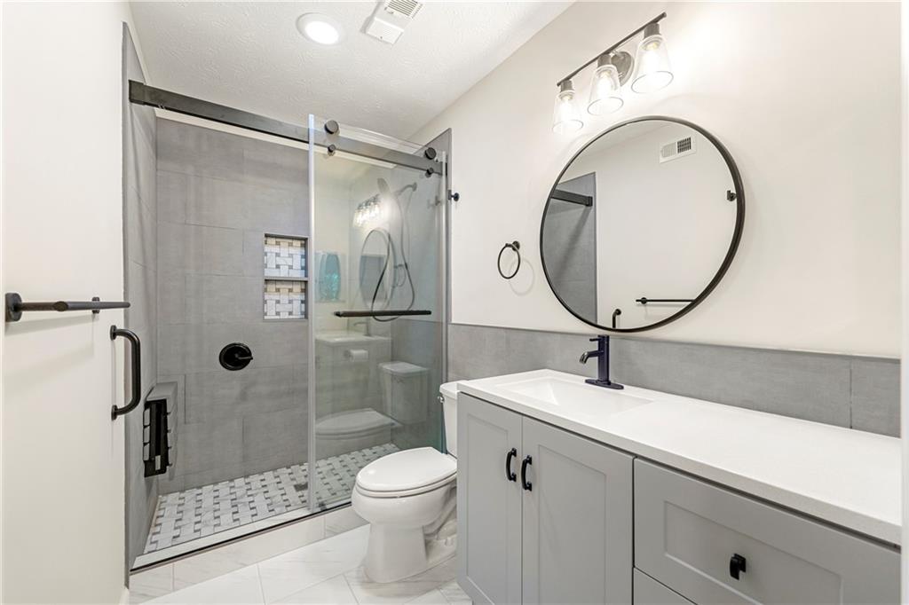 475 Mount Vernon Highway Northeast, Unit 226C Atlanta, GA 30328 - Photo 12 of 24 a bathroom with a sink toilet and shower