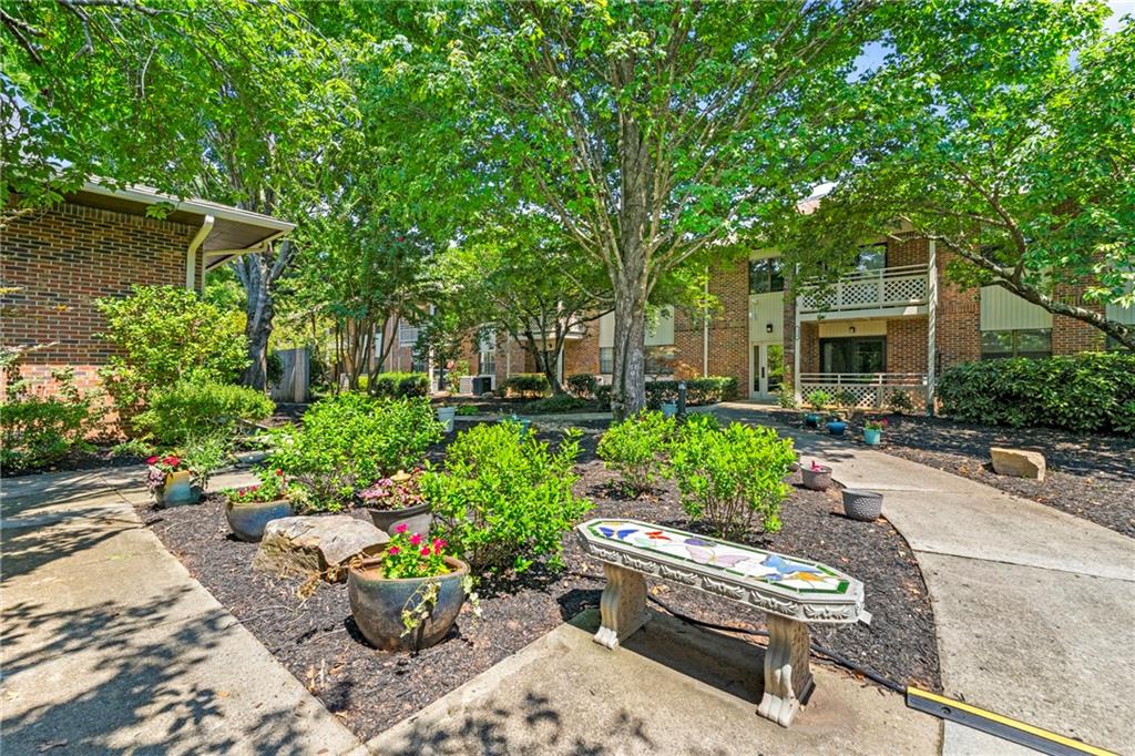 475 Mount Vernon Highway Northeast, Unit 226C Atlanta, GA 30328 - Photo 14 of 24 a view of a backyard with sitting area and garden