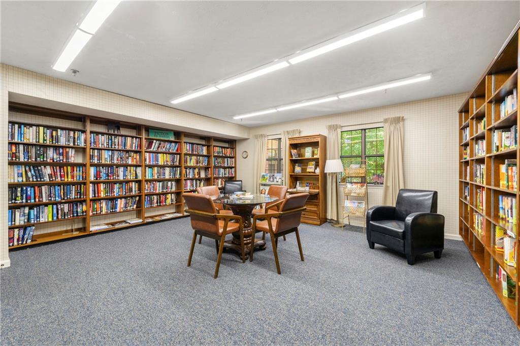 475 Mount Vernon Highway Northeast, Unit 226C Atlanta, GA 30328 - Photo 16 of 24 a view of a livingroom with furniture and a bookshelf