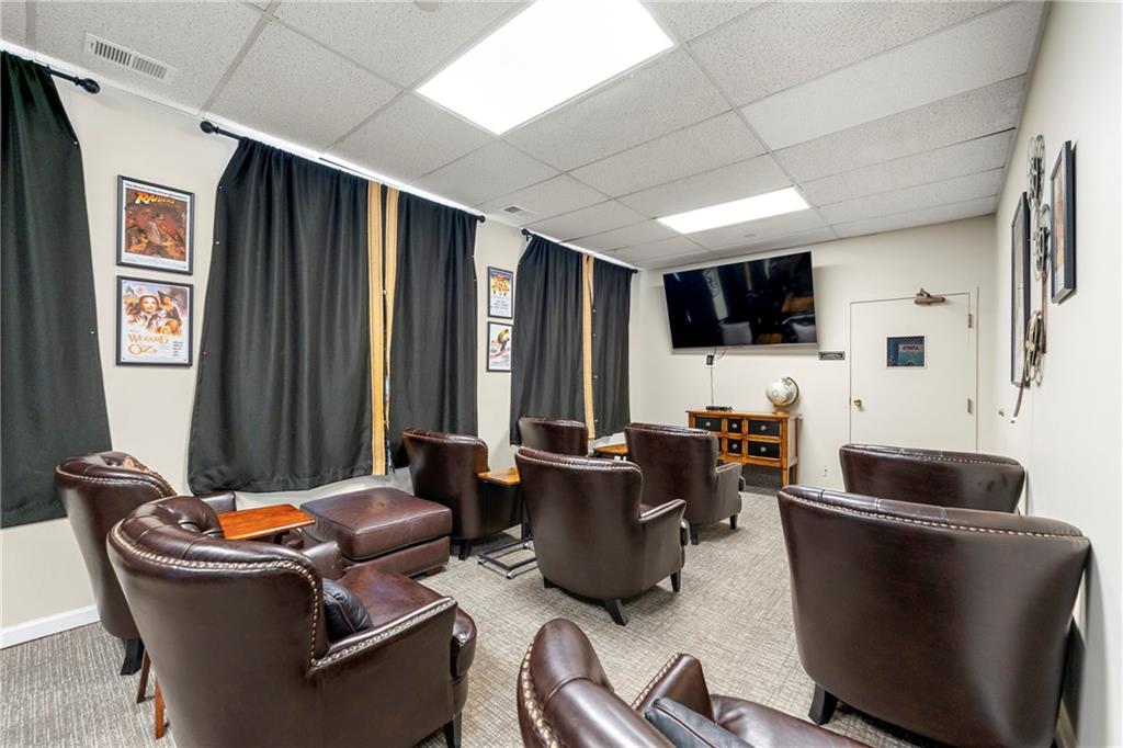 475 Mount Vernon Highway Northeast, Unit 226C Atlanta, GA 30328 - Photo 20 of 24 a living room with fireplace furniture and a flat screen tv