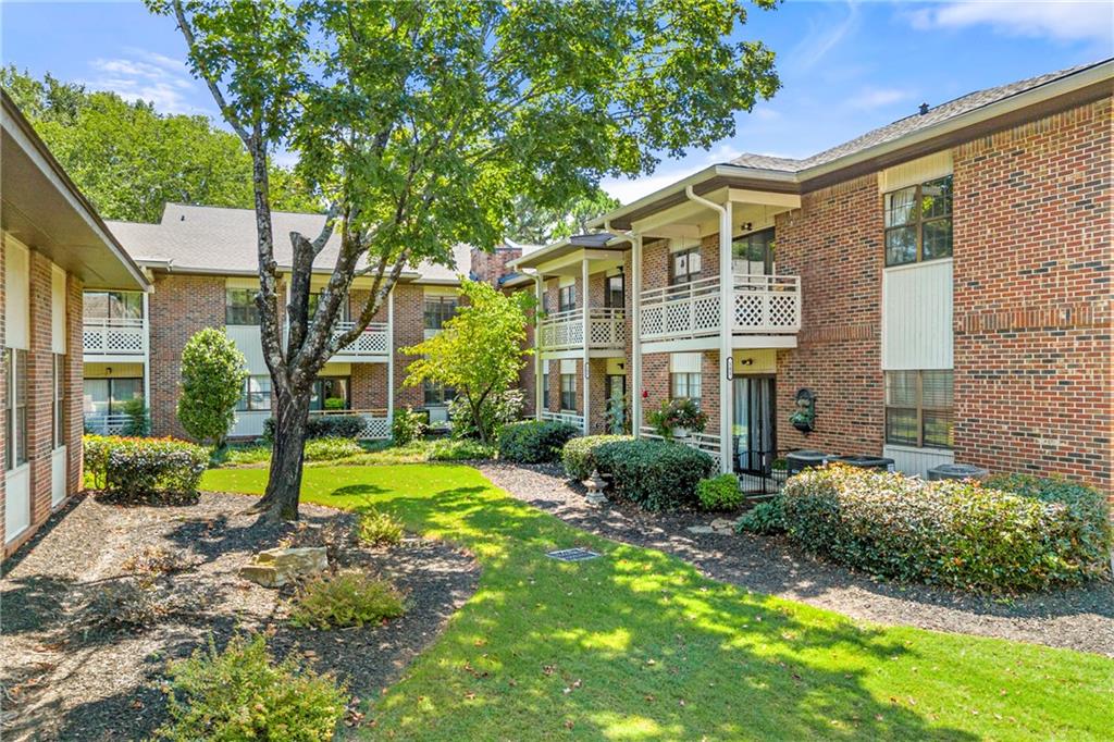 475 Mount Vernon Highway Northeast, Unit 226C Atlanta, GA 30328 - Photo 21 of 24 a view of a big yard with plants and large trees