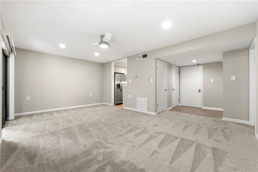 475 Mount Vernon Highway Northeast, Unit 226C Atlanta, GA 30328 - Photo 3 of 24 a view of an empty room and chandelier fan