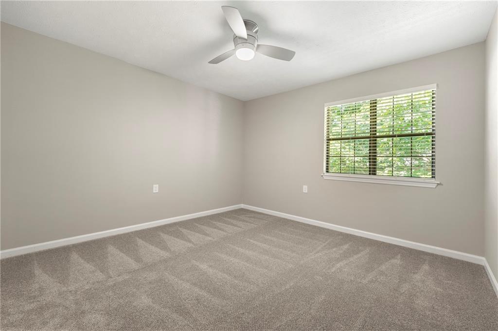 475 Mount Vernon Highway Northeast, Unit 226C Atlanta, GA 30328 - Photo 9 of 24 an empty room with a window and a fan