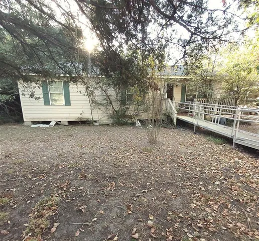 a view of a backyard with a tree