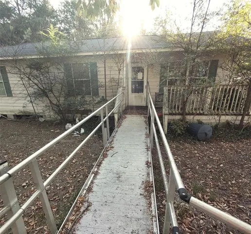 a view of balcony with wooden floor and fence