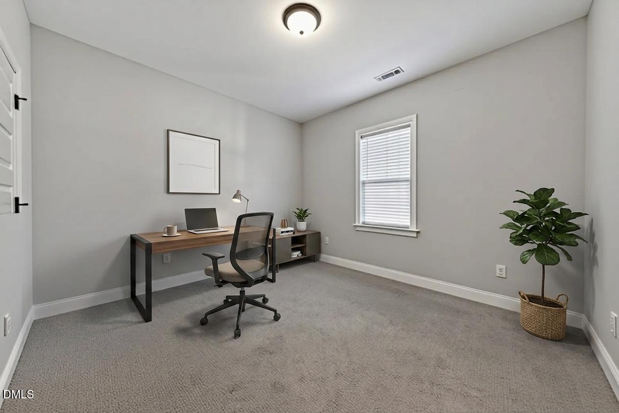 9205 Raccoon Drive Middlesex, NC 27557 - Photo 14 of 20 a view of a workspace with a window and a chair