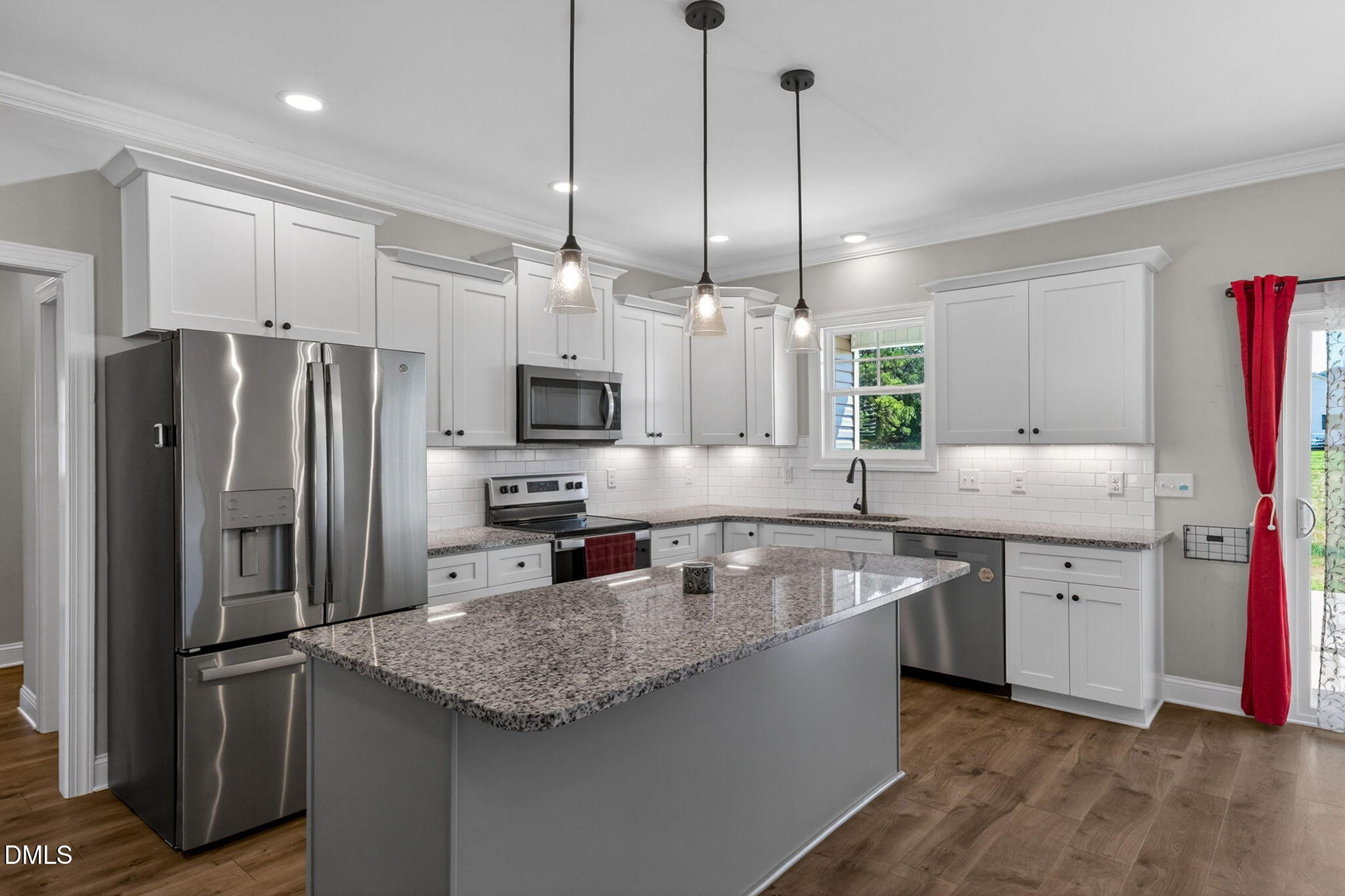 9205 Raccoon Drive Middlesex, NC 27557 - Photo 6 of 20 a kitchen with stainless steel appliances granite countertop a sink a stove a refrigerator and island