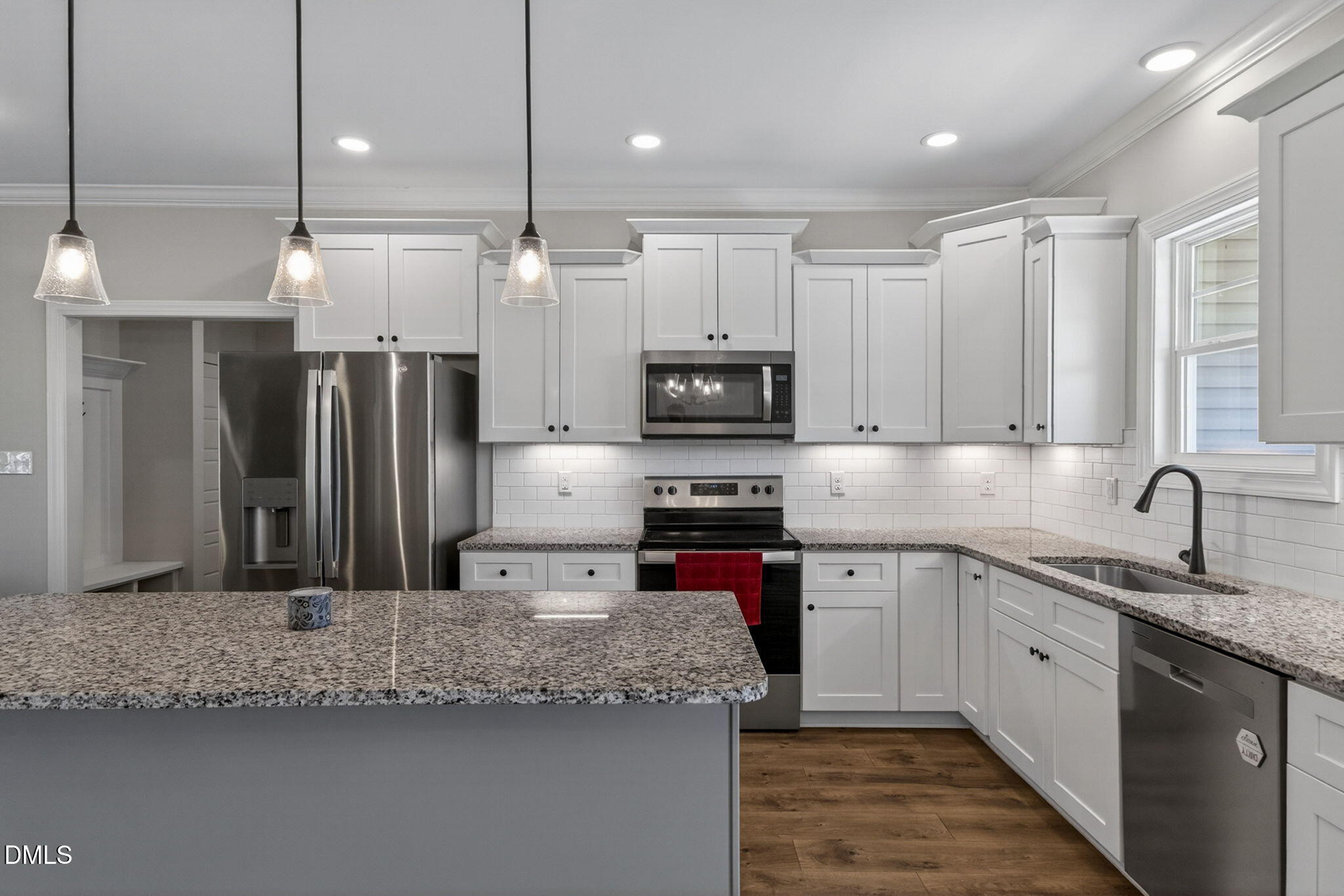 9205 Raccoon Drive Middlesex, NC 27557 - Photo 7 of 20 a kitchen with stainless steel appliances granite countertop a sink refrigerator and microwave