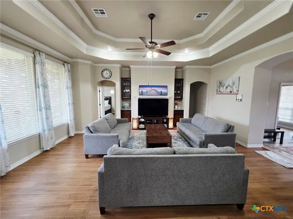 a spacious bedroom with a bed and a dresser in it