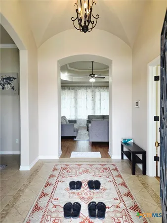 a bedroom with a bed and a ceiling fan