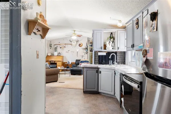 a kitchen with stainless steel appliances granite countertop a sink and dishwasher a refrigerator with wooden floor