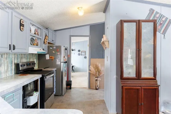 a kitchen with stainless steel appliances granite countertop a refrigerator and a stove