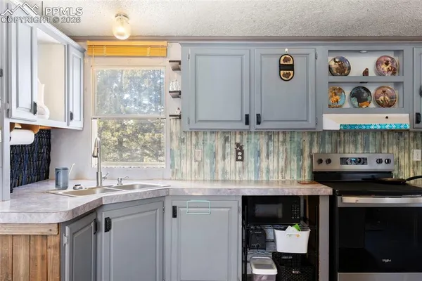 a kitchen with stainless steel appliances granite countertop a stove and a sink