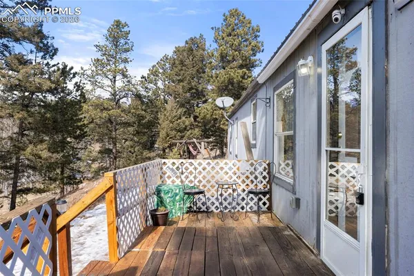 a balcony with wooden floor and outdoor seating