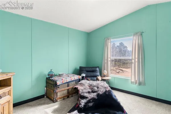 a bedroom with a bed and windows