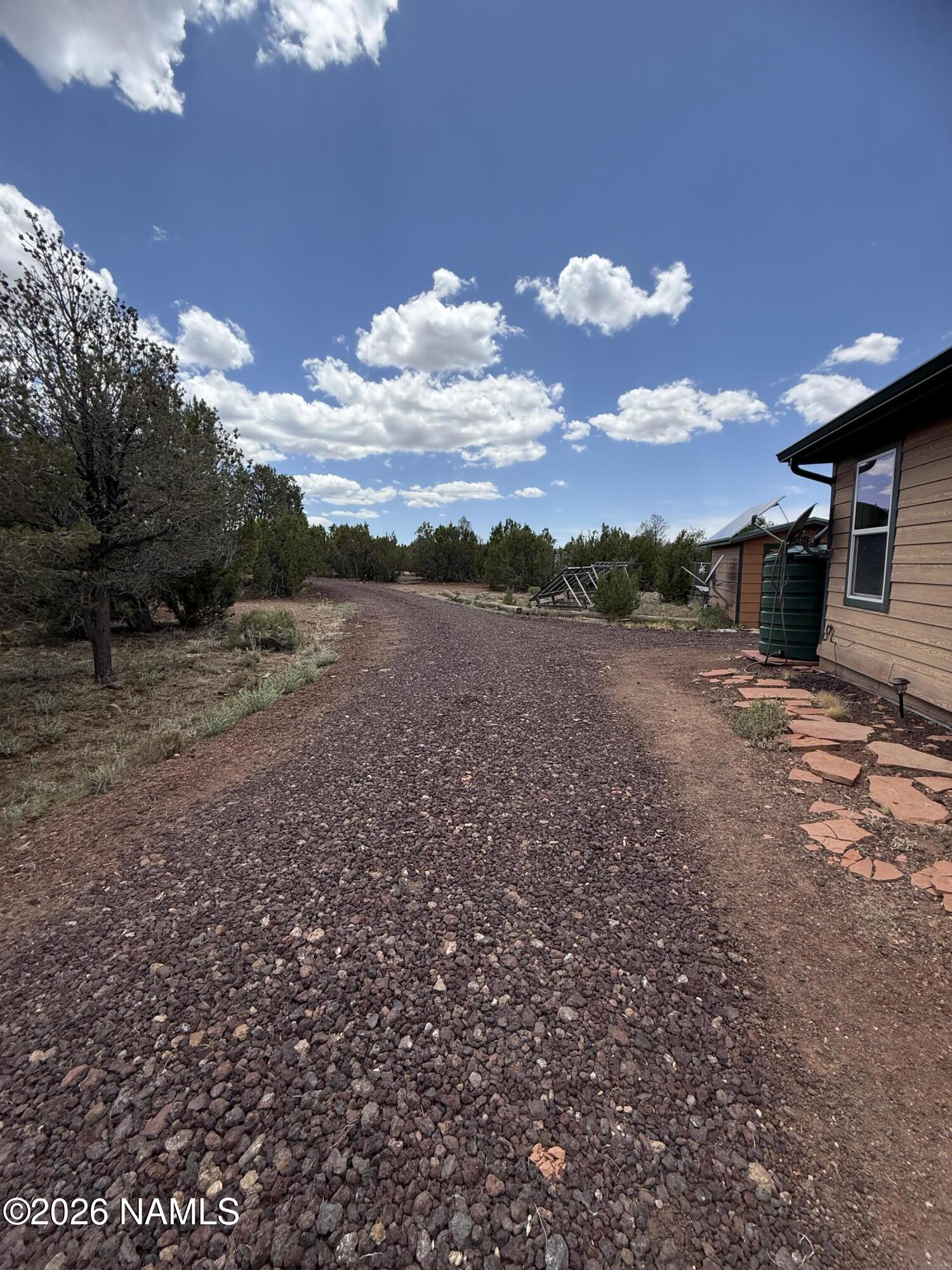 1431 East Cedar Road Williams, AZ 86046 - Photo 8 of 51 a view of a dry yard with wooden fence