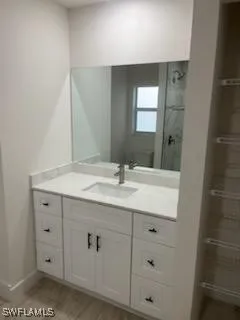 a bathroom with a granite countertop sink and a mirror
