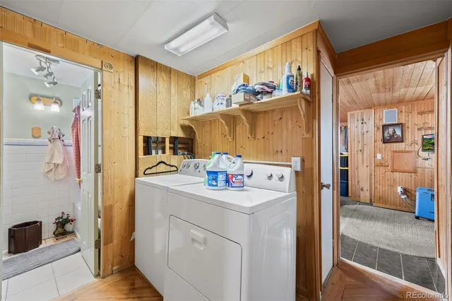 a utility room with a sink a washer and dryer next to a window